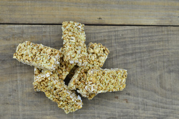 Heap of cereal bars on wooden background.