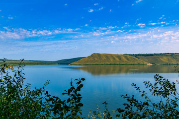 panorama nature landscape photography of mountain hills lake smooth peaceful waters shore line reservation country side environment in summer time season clear weather 