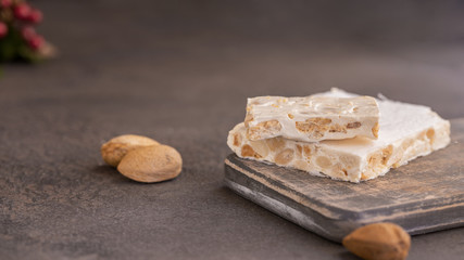 Fototapeta na wymiar El Turron de Alicante or The nougat of Alicante made with lightly roasted whole almonds and honey. Popular Spanish Christmas sweet.