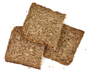 Slices of wholemeal dark bread isolated on a white background in close-up (high details)