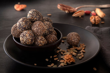 Healthy organic energy granola bites with nuts, cacao, banana and honey - sports food, vegetarian raw snack