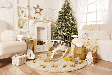 White Christmas interior. Beautiful Christmas tree, armchair, baskets, gifts, skates, stairs and other decoration