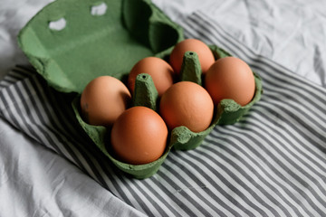 Chicken eggs on cardboard tray for background. Top view 