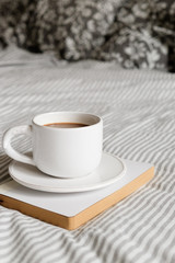 white cup with a pattern of deer. Coffee in a cup. Morning coffee.