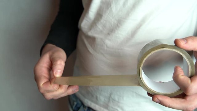 Man hands working with duct tape