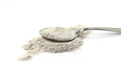 cappuccino powder in a metal spoon isolated in white background.