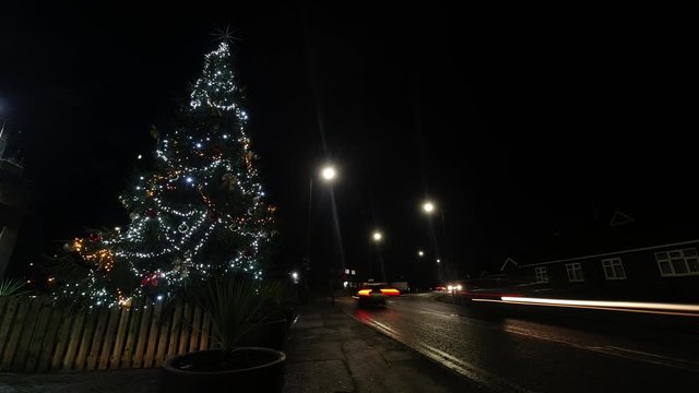Christmas tree fairy lights speeding night traffic timelapse countdown rushing concept.