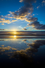 Fototapeta na wymiar Dramatic mirror reflection of sunset and clouds in the still waters os Lake Tyrrell, a salt lake in north west Victoria, Australia.