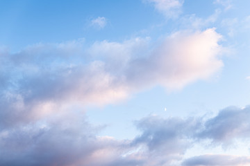 Scenic view of blue sky with clouds and moon at sunset