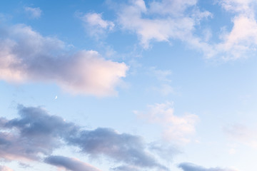 Scenic view of blue sky with clouds and moon at sunset