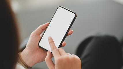 Cropped shot of businesswoman using blank screen smartphone