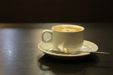 cup of coffee on wooden table