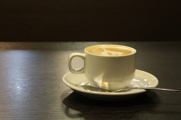 cup of coffee on wooden table