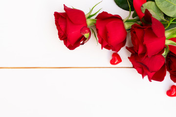 Red blooming roses on wood