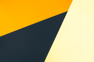 Orange, black and yellow paper color for background. Minimal geometric shapes and lines in contrast colours. Flat lay, copy space, top view.