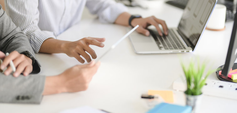 Cropped shot of young professional UX web developer team working on their project together