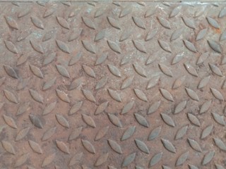 Rusty steel sheet checkered plate backgrounds and textures closeup for wallpaper interior design...