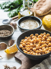 Set of ingredients for cooking homemade traditional hummus on a white wood background. Copy space