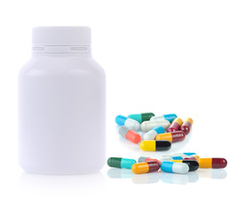 White plastic medicine bottle and medical capsules on white background.