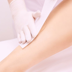 Hair removal at spa luxury studio. Woman legs wax with shugaring. Hot sugar