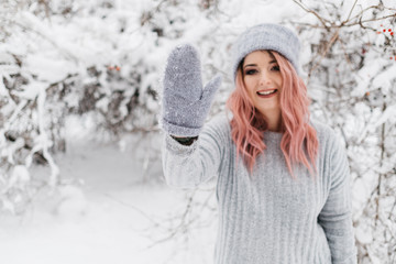 Young Blonde Woman in Gray Sweater is Enjoying Winter