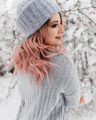 Young Blonde Woman in Gray Sweater is Enjoying Winter