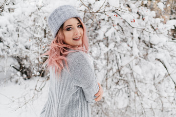 Young Blonde Woman in Gray Sweater is Enjoying Winter