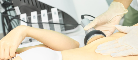 Fototapeta premium Cavitation rf body treatment. Female ultra sound lipo machine. Spa contouring. Doctor hands