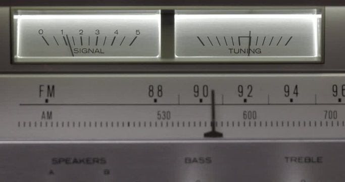Vintage radio receiver and amplifier with fm scale. Tuning Analog Radio Frequency on Scale of the Vintage Receiver. Searching for stations on the old radio