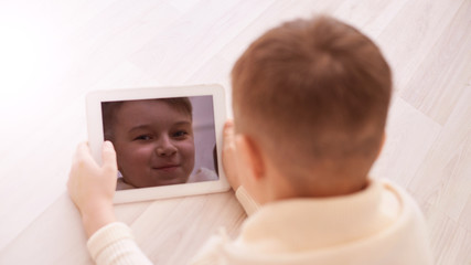 Cute boy. Face on screen. Light background. Horizontal
