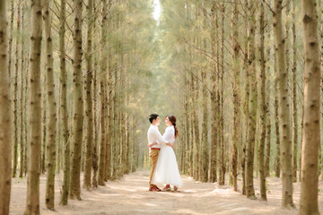 Young asian groom and bride posing and smiling for pre-wedding shot © bookybuggy
