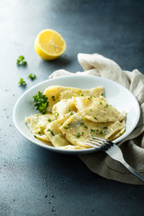 Homemade ravioli with lemon and herbs