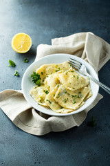 Homemade ravioli with lemon and herbs