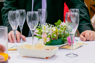hands of men holding glasses of champagne for celebrated special occasion wedding party or meeting between friends, company. 