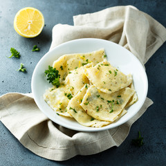 Homemade ravioli with lemon and herbs