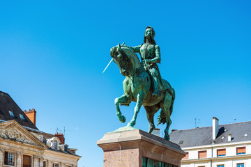 Fototapeta na wymiar ORLEANS, FRANCE - May 8, 2018: statue Joan of Arc is an 1874 French gilded bronze equestrian sculpture of Orleans Cathedral in Orleans, France