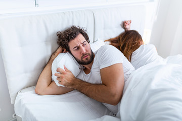 Obraz premium Relationship concept. Young couple lying on the bed. Couple having a fight in the bed. concept about relationship and problems between couples. Sexual frustration. Lovers ignore each other
