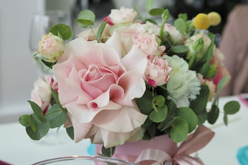 beautiful bouquet of flowers with a rose is on the holiday table. Decoration, design, female