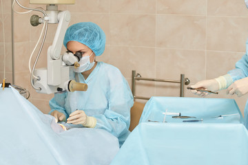 Ophthalmology laser microscope operation. Doctor in clinic. Patient eye treatment. Myopia and...