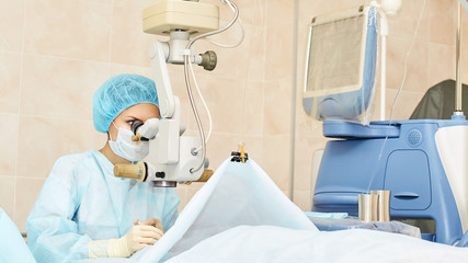 Ophthalmology laser microscope operation. Doctor in clinic. Patient eye treatment. Myopia and...
