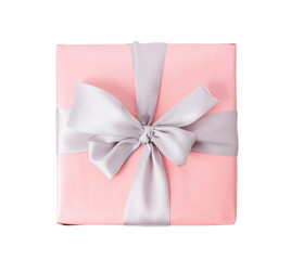 Pink gift box with ribbon on white