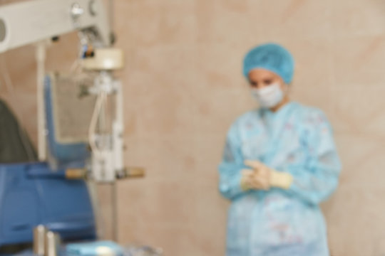 Ophthalmology laser microscope operation. Clinic room with doctor and parient. Blur background. Unfocus, selective focus