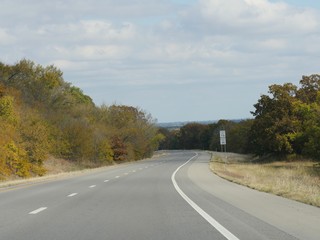 Winding paved road with colorful foliage and trees in autumn