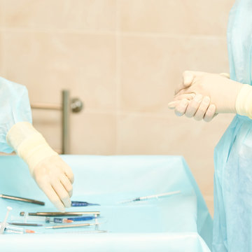 Ophthalmology laser microscope operation. Clinic room with doctor and parient. Gloves and medicine tools