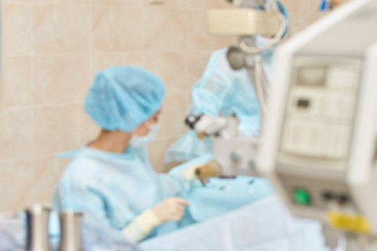 Ophthalmology laser microscope operation. Clinic room with doctor and parient. Blur background. Unfocus, selective focus