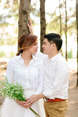 Young asian groom and bride posing and smiling for pre-wedding shot © bookybuggy