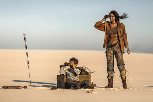 Post apocalyptic Woman and Boy Outdoors in a Wasteland