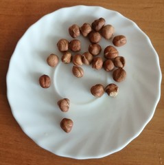 hazelnuts scattered on a white plate