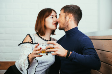 Young couple guy and girl drink whiskey on a date