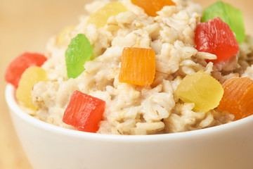 Oatmeal breakfast bowl. Organic healthy food with candied fruit